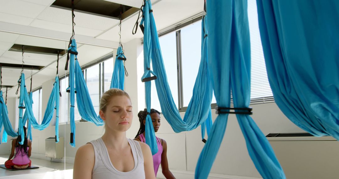 Women Meditating During Antigravity Yoga Class in Modern Studio - Free Images, Stock Photos and Pictures on Pikwizard.com