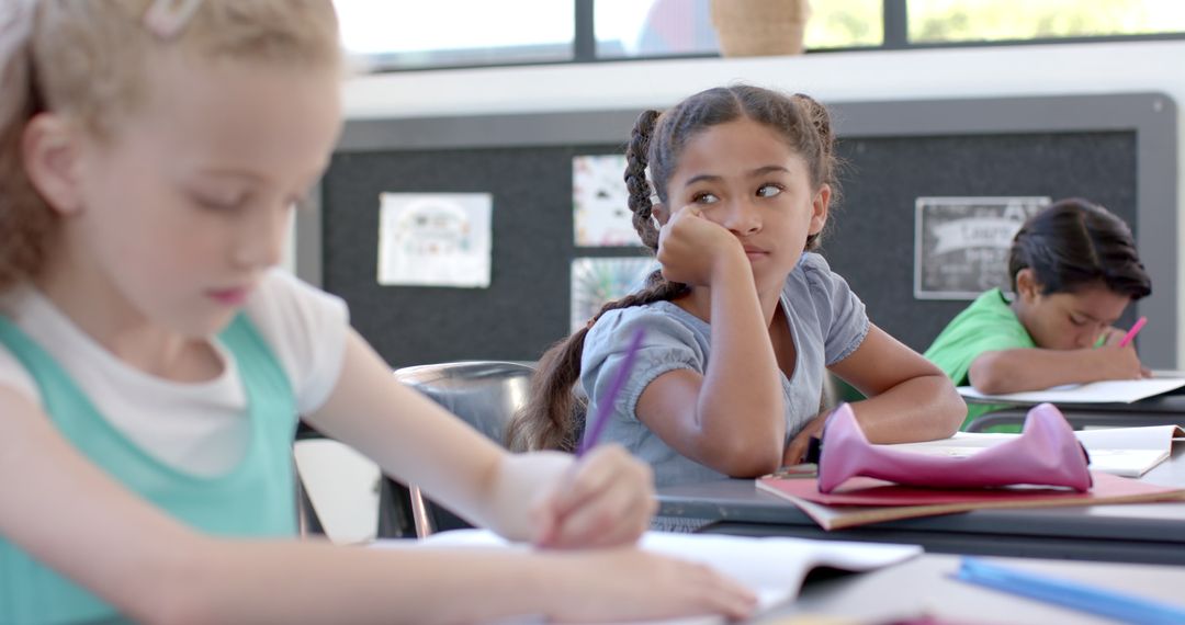 Thoughtful Biracial Girl in Classroom during Study Session