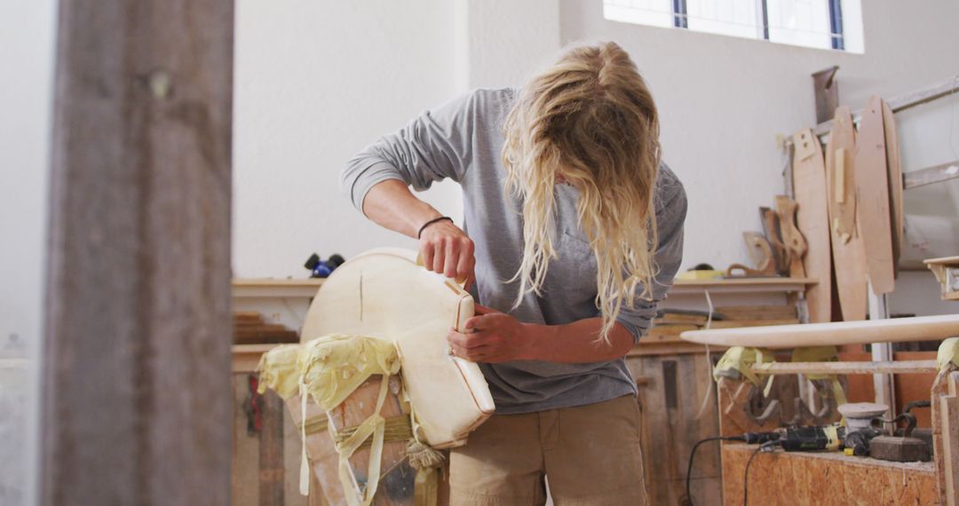 Skilled Craftsman Shaping Surfboard in Workshop - Free Images, Stock Photos and Pictures on Pikwizard.com