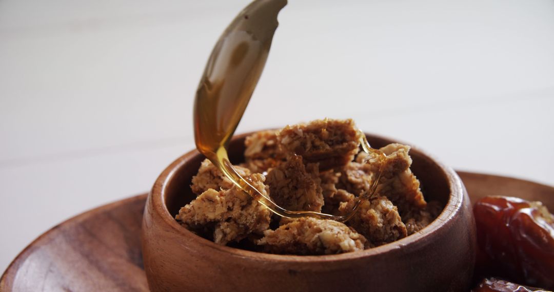 Honey Drizzling on Corn Flakes in Wooden Bowl - Free Images, Stock Photos and Pictures on Pikwizard.com