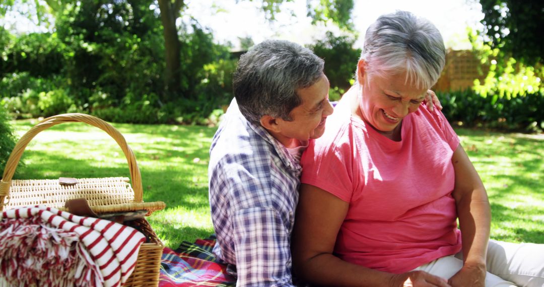 Elderly Couple Sharing Tender Moment During Relaxing Picnic