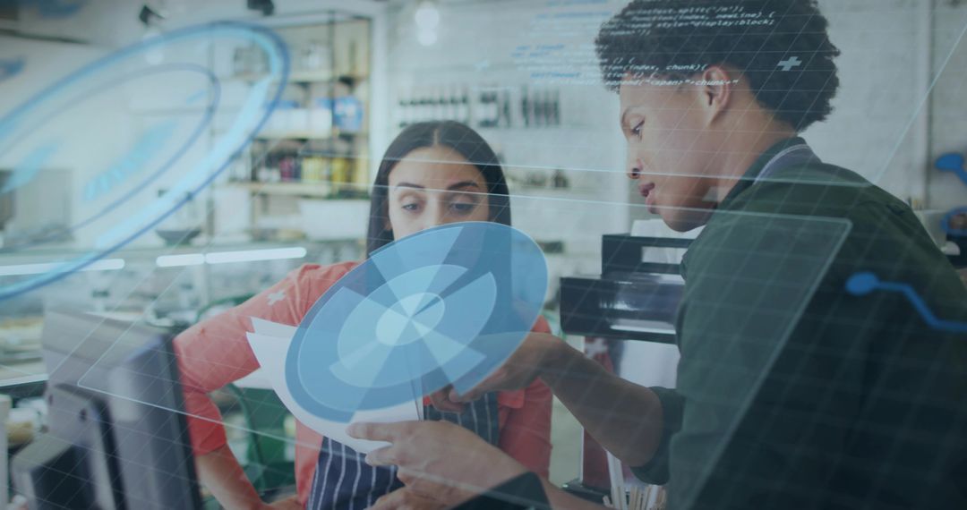 Colleagues Discussing Digital Schematics in Craft Workshop