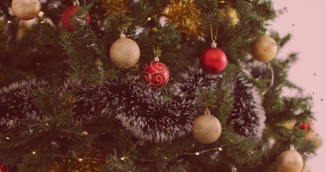 Festive Christmas Tree with Ornaments Against Pink Background