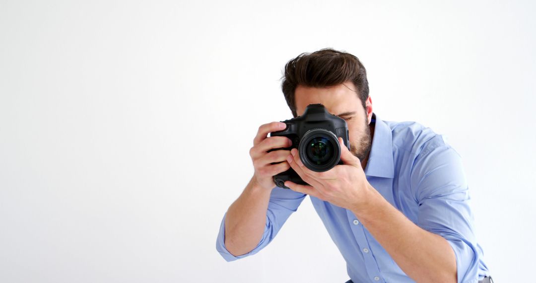 Young Male Photographer Taking Picture with Professional Camera - Free Images, Stock Photos and Pictures on Pikwizard.com