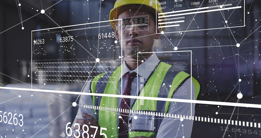 Engineer examining digital analytics overlay in warehouse wearing hard hat hi-vis vest
