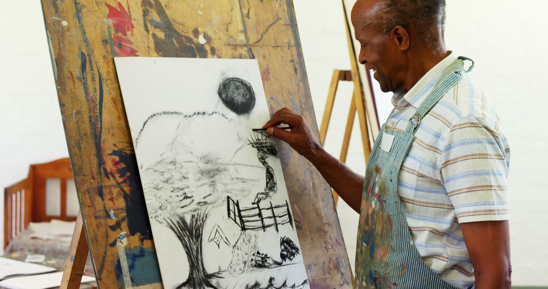 African American Artist Creating Charcoal Drawing at Easel - Free Images, Stock Photos and Pictures on Pikwizard.com