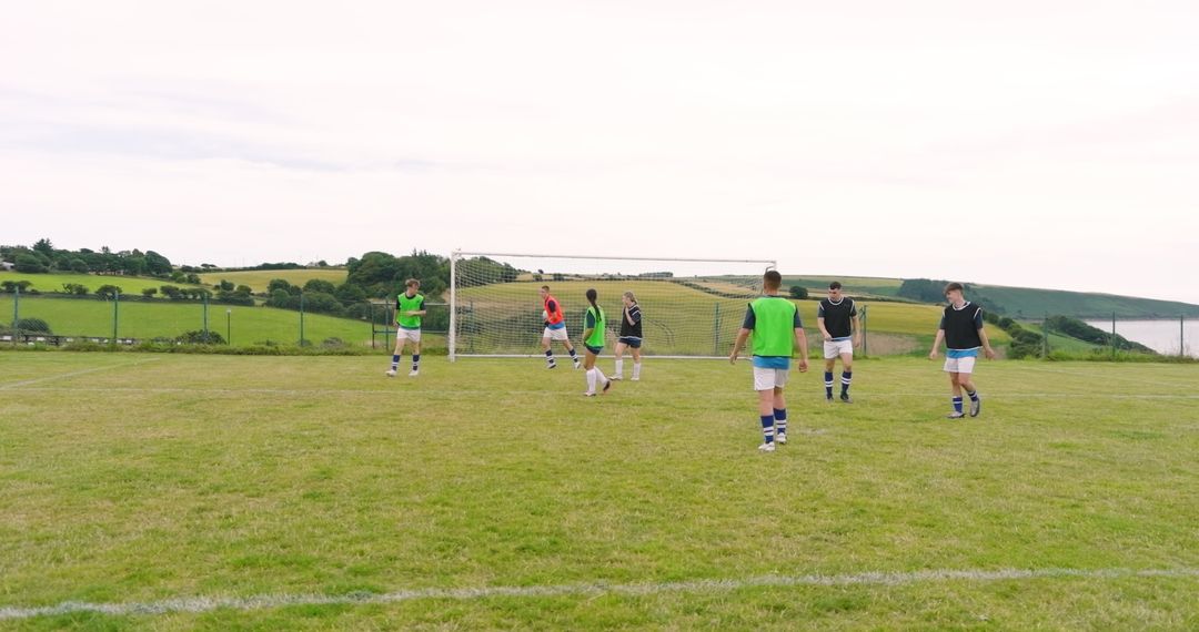 Youth Soccer Team Practicing on Rural Grassland Field