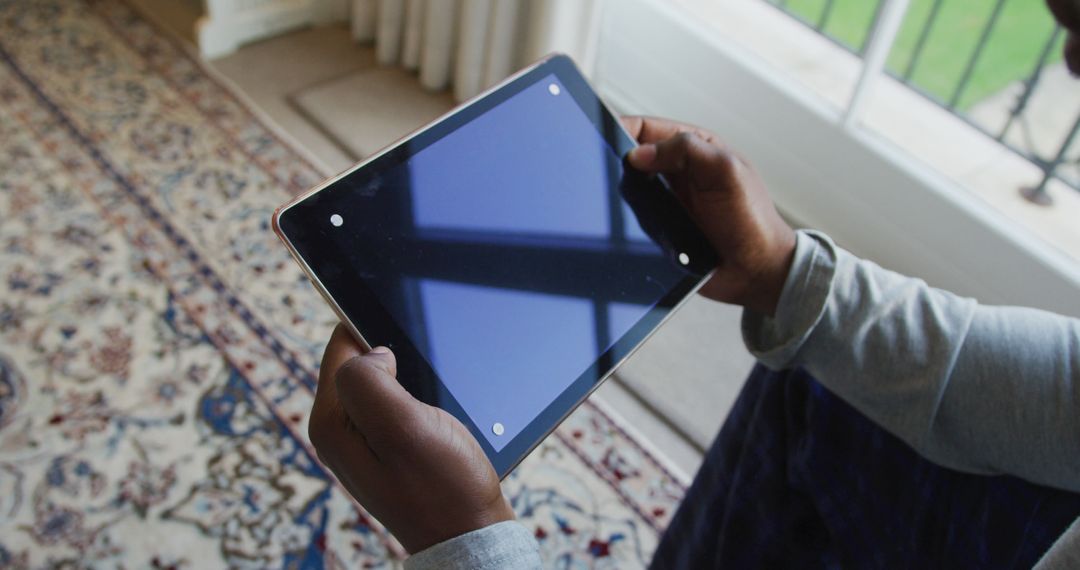 Person holding tablet with blank screen while sitting indoors - Free Images, Stock Photos and Pictures on Pikwizard.com