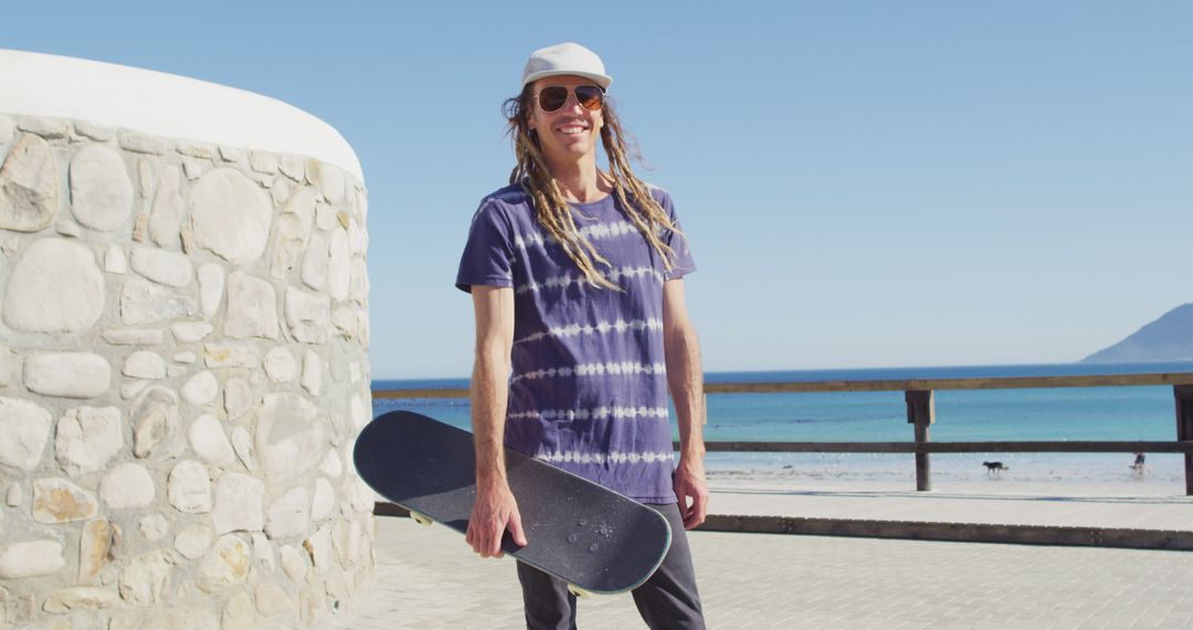 Skateboarder with Dreadlocks by Beach on Sunny Day - Free Images, Stock Photos and Pictures on Pikwizard.com