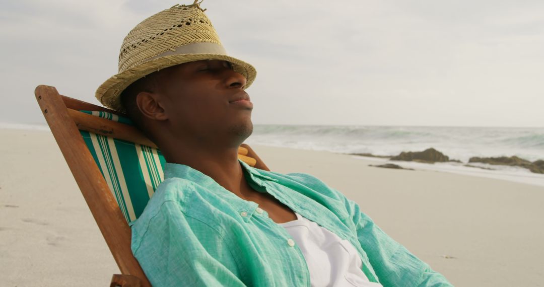 Man Relaxing on Sun Lounger at Peaceful Beachfront