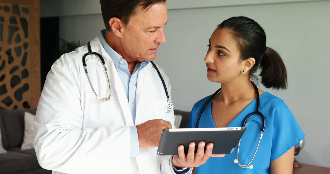 Doctor Discussing Patient Data with Nurse Using Digital Tablet - Free Images, Stock Photos and Pictures on Pikwizard.com