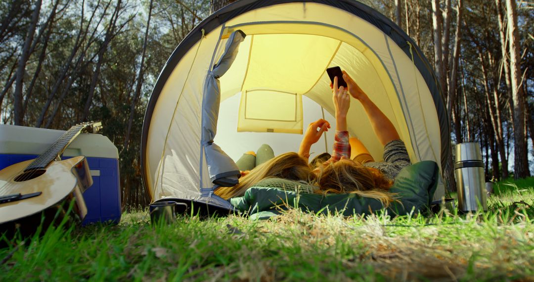 Friends Relaxing in Tent at Forest Campground - Free Images, Stock Photos and Pictures on Pikwizard.com