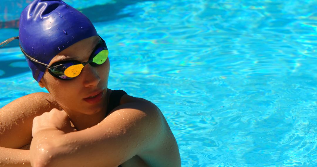 Competitive Swimmer Resting at Poolside in Bright Sunlight - Free Images, Stock Photos and Pictures on Pikwizard.com