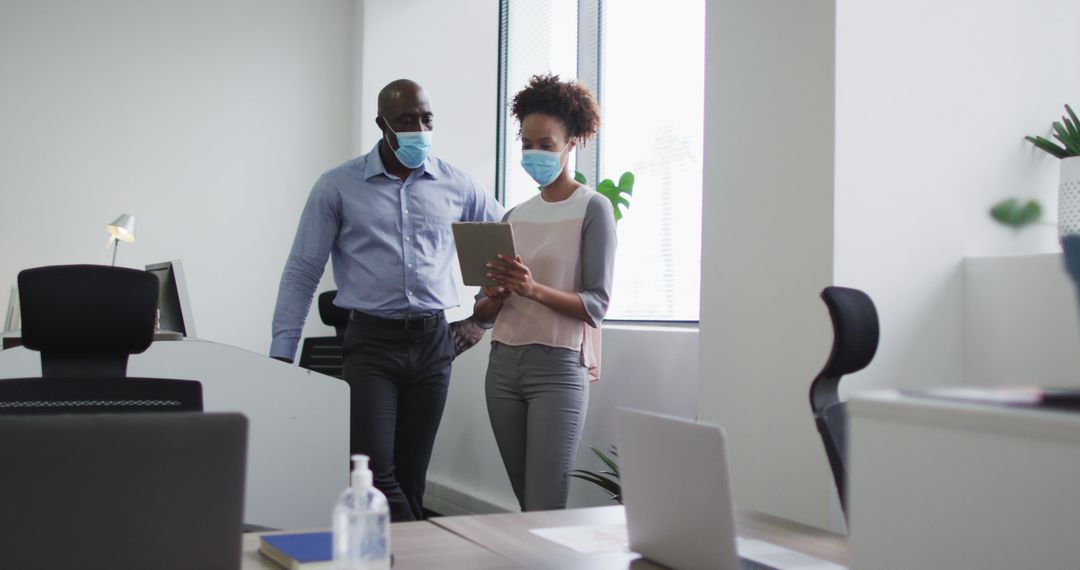 Professionals Collaborating with Tablet in Modern Office