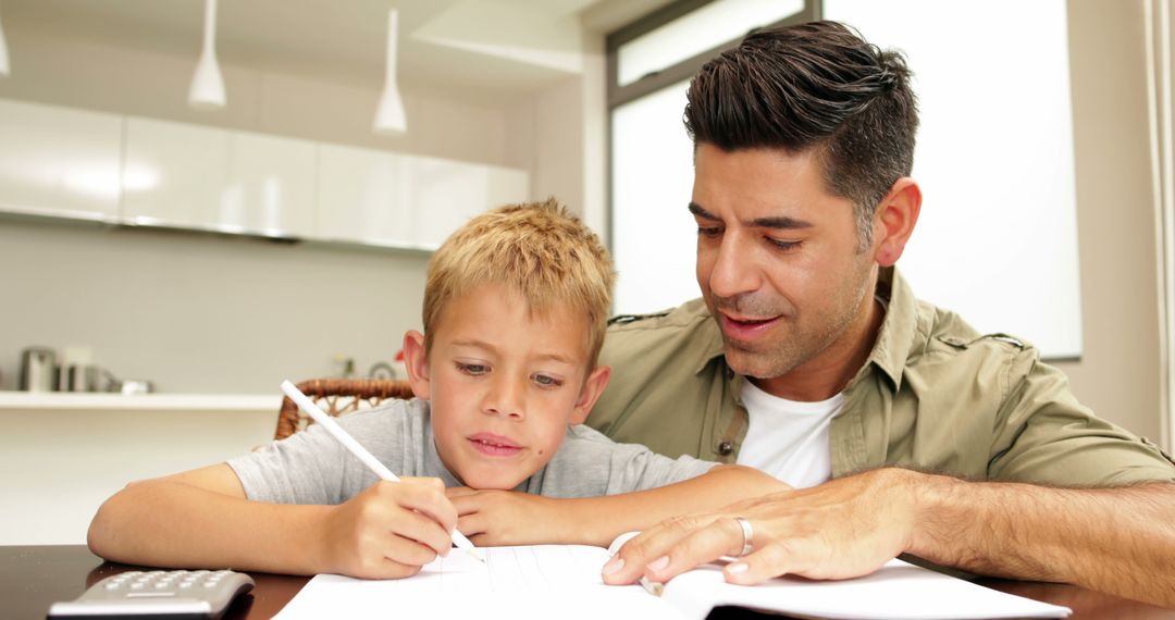 Father Helping Son with Homework in Kitchen at Home - Free Images, Stock Photos and Pictures on Pikwizard.com