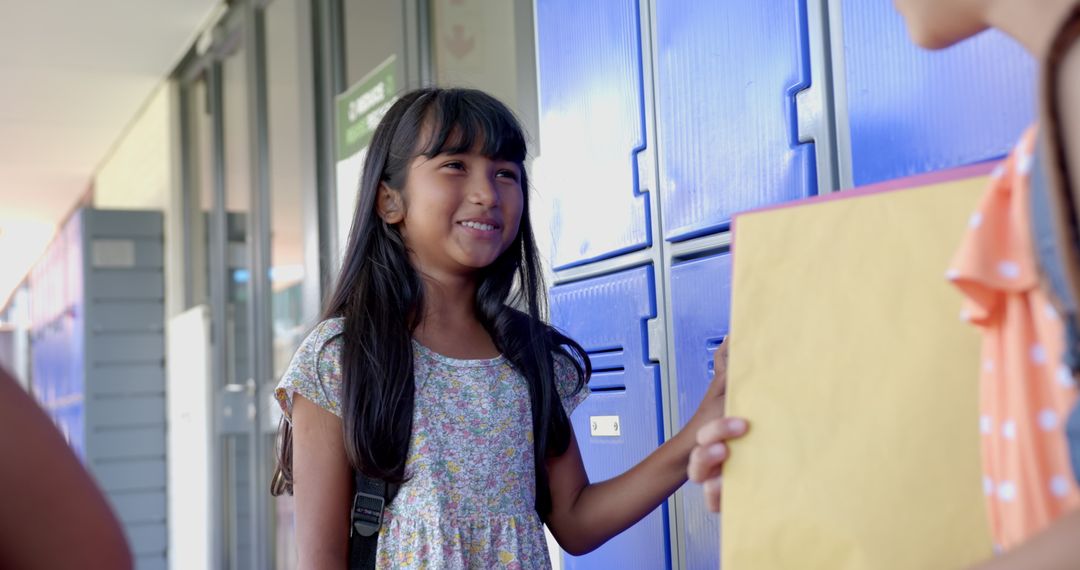 Smiling Schoolgirl with Folder Interacting Near Lockers