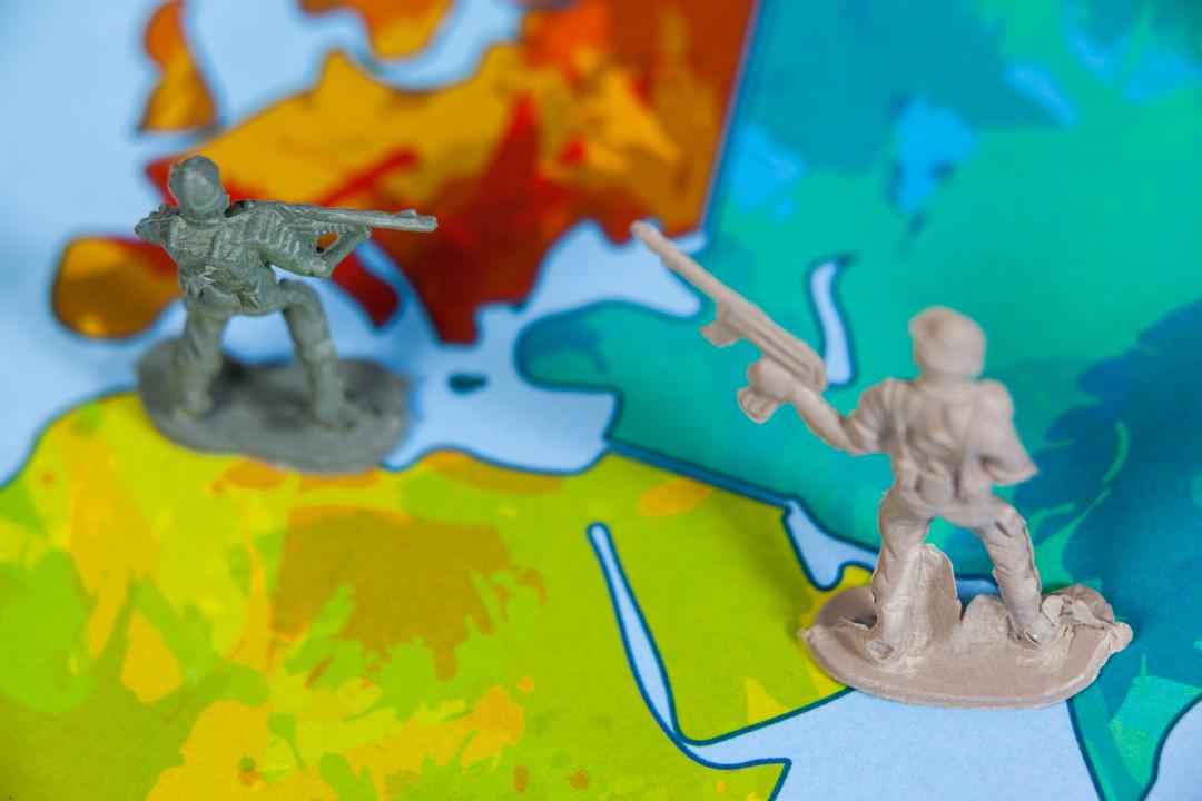 Miniature Army Soldiers on Colorful Map - Free Images, Stock Photos and Pictures on Pikwizard.com