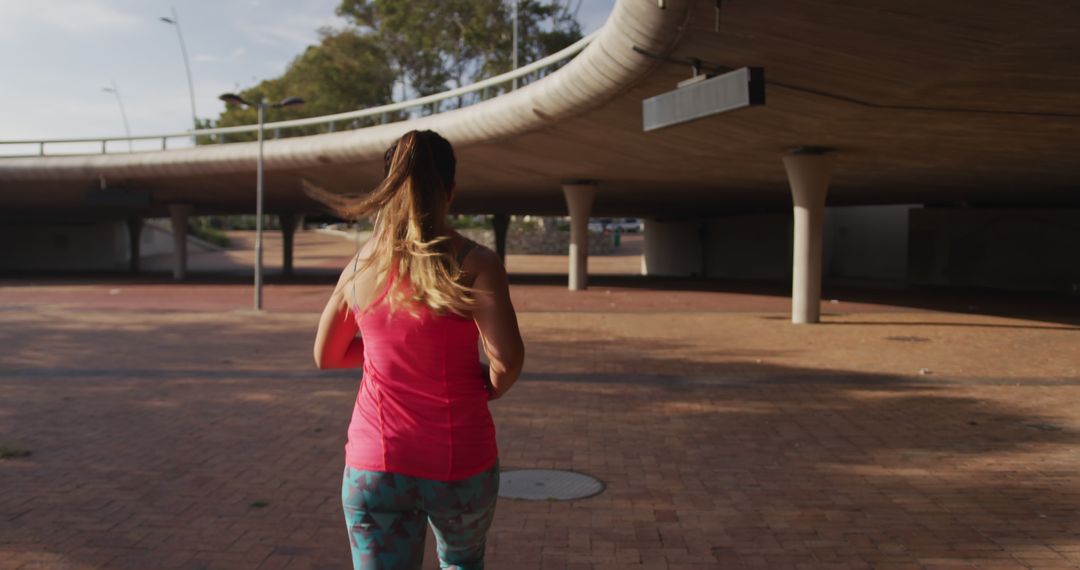 Woman Jogging Under Urban Overpass - Free Images, Stock Photos and Pictures on Pikwizard.com