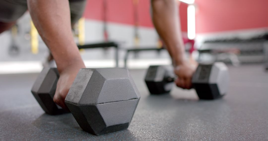 Close-Up of Person Gripping Heavy Dumbbells in Gym Workout