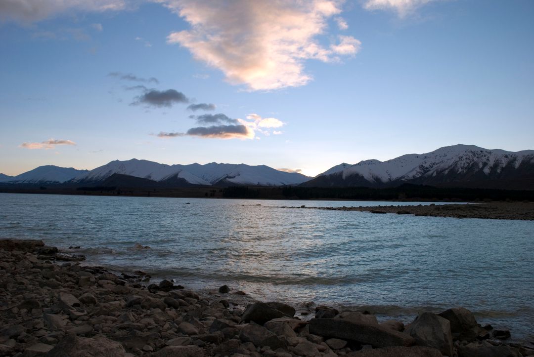 Serene Mountain Lake at Sunset with Snow-Capped Peaks - Free Images, Stock Photos and Pictures on Pikwizard.com