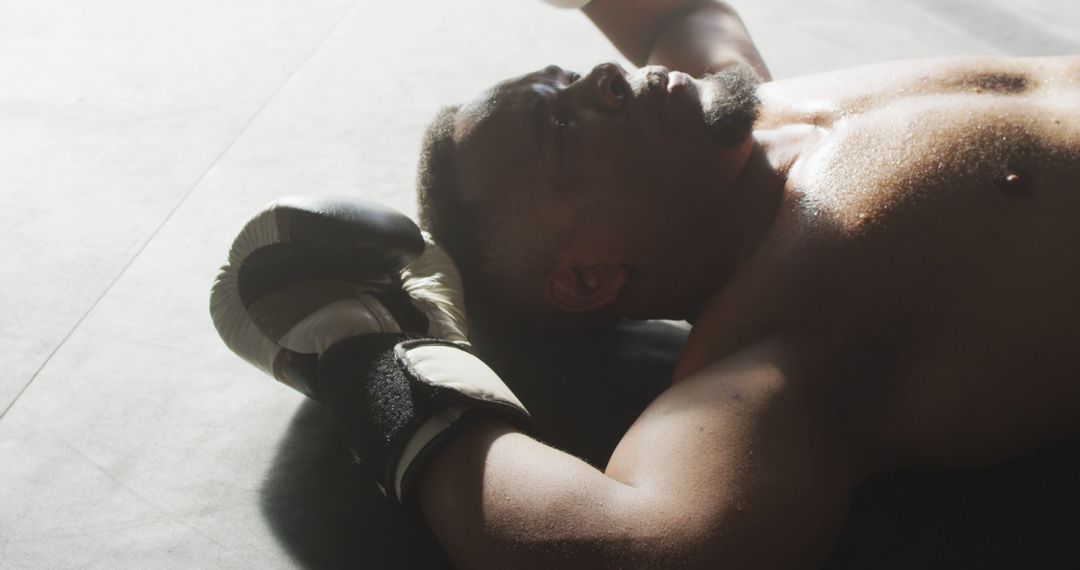 Exhausted Boxer Lying in the Boxing Ring After a Tough Match - Free Images, Stock Photos and Pictures on Pikwizard.com