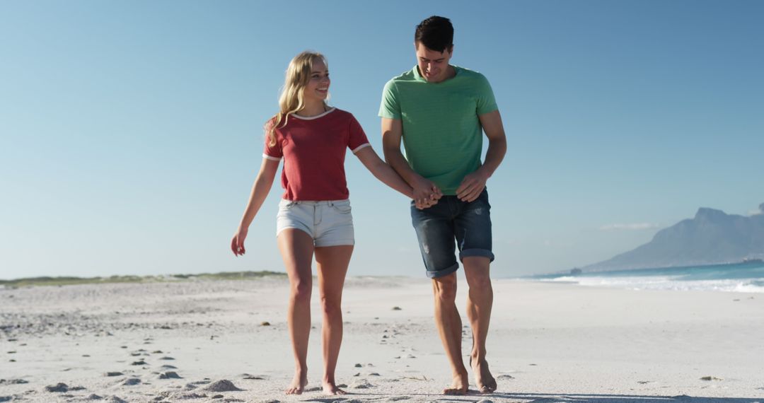 Happy Couple Walking on Beach During Summer Day - Free Images, Stock Photos and Pictures on Pikwizard.com