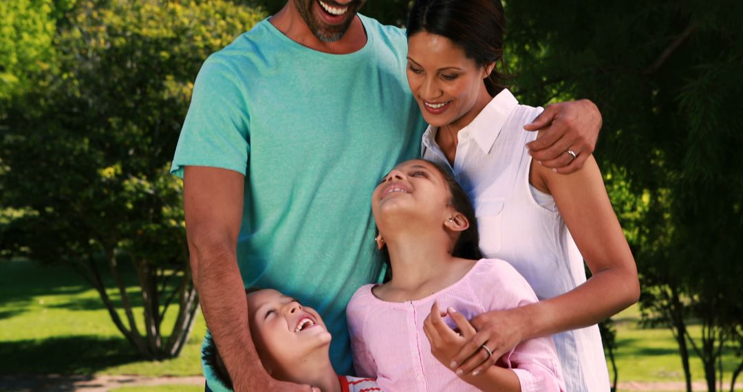 Diverse Family Laughing Together Outdoors on Sunny Day - Free Images, Stock Photos and Pictures on Pikwizard.com