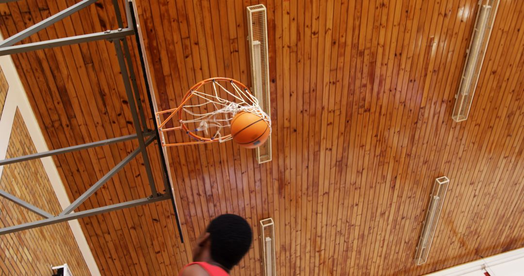 Basketball Player Aiming for Hoop During Game in Indoor Gym - Free Images, Stock Photos and Pictures on Pikwizard.com