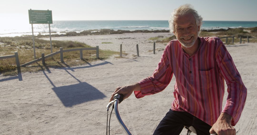 Senior Man Biking at Seaside in Bright Sunshine - Free Images, Stock Photos and Pictures on Pikwizard.com