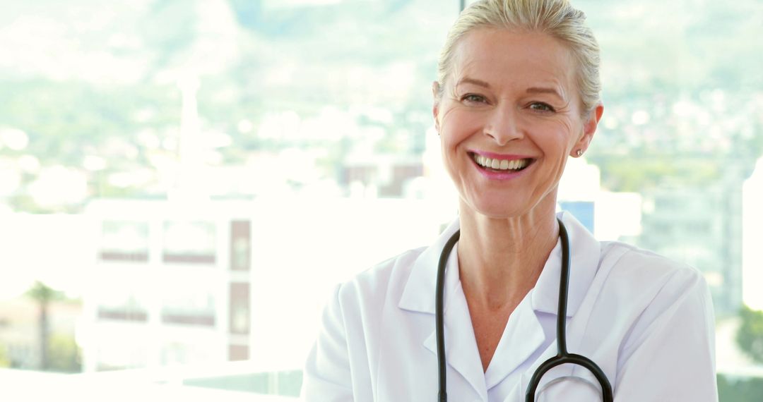 Smiling Senior Female Doctor with Stethoscope in Bright Office - Free Images, Stock Photos and Pictures on Pikwizard.com