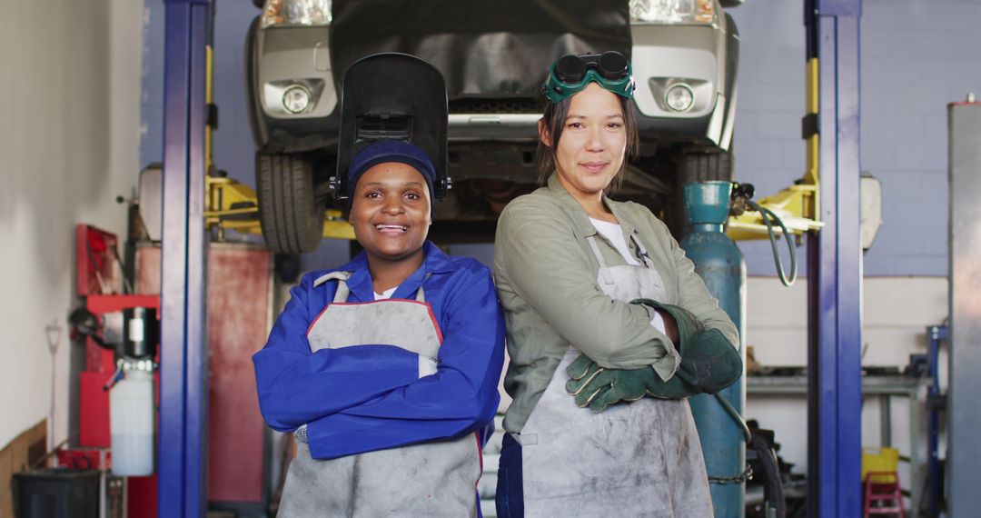 Confident Female Auto Mechanics Posing in Repair Garage - Free Images, Stock Photos and Pictures on Pikwizard.com