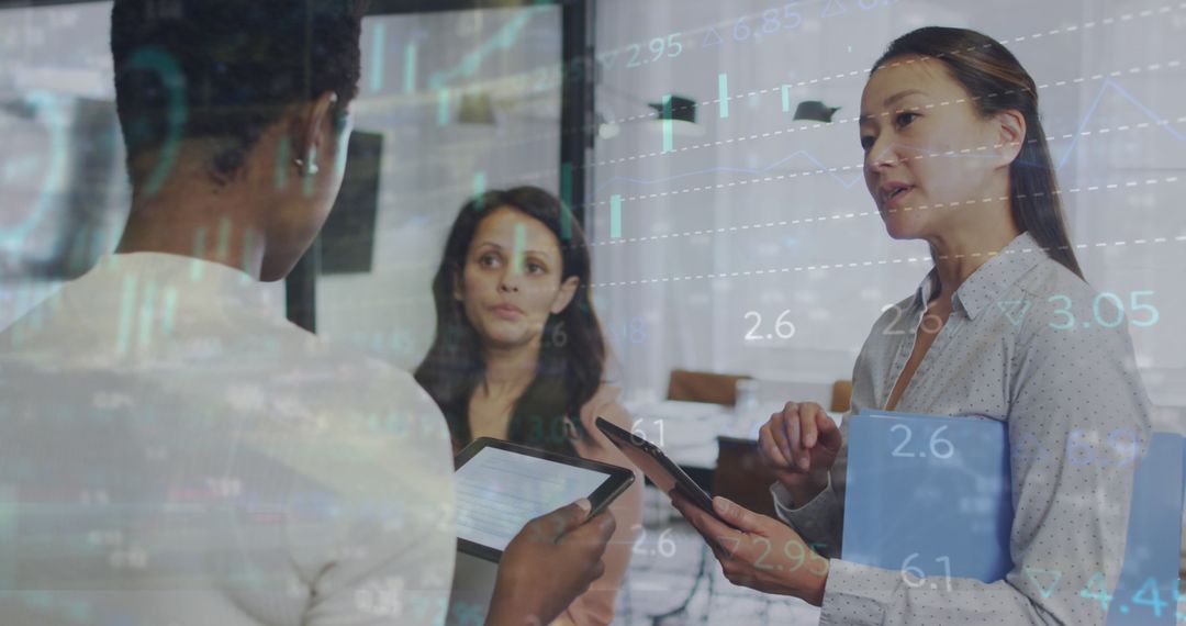 Diverse Businesswomen Discussing Strategies with Financial Data Overlay