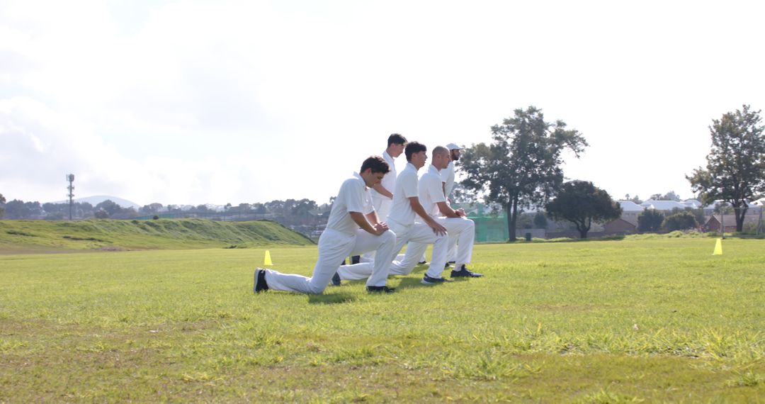 Cricket Team Warming Up on Field with Lunges