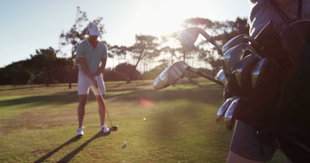 Golfer Preparing Shot on Golf Course under Sunlight