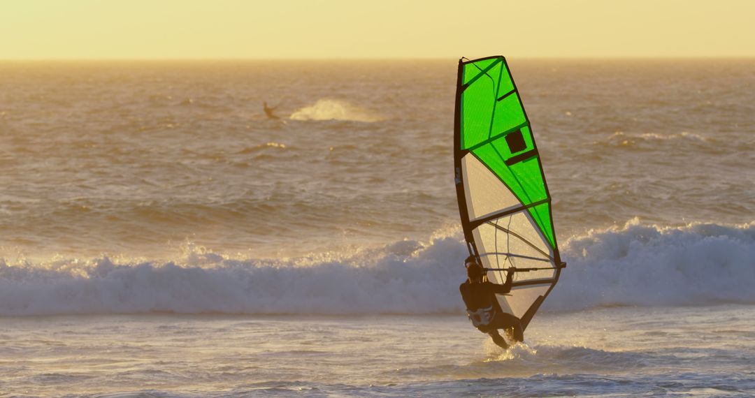 Windsurfer Riding Waves at Sunset - Free Images, Stock Photos and Pictures on Pikwizard.com