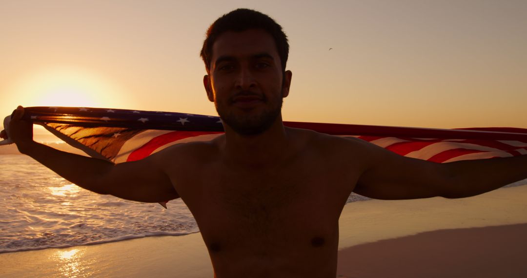 Patriotic Man Holding American Flag on Beach at Sunset - Free Images, Stock Photos and Pictures on Pikwizard.com