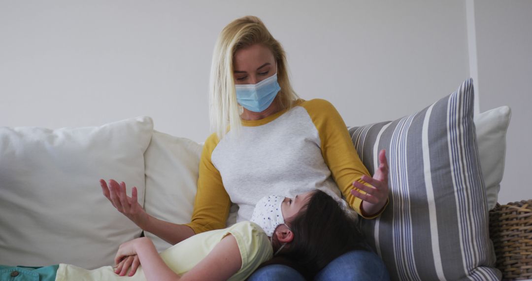 Mother with Face Mask Comforting Sick Child on Sofa - Free Images, Stock Photos and Pictures on Pikwizard.com