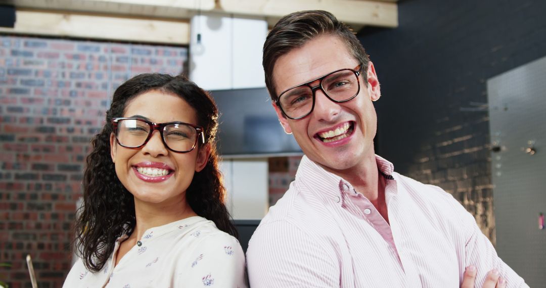 Confident Business Executives Smiling with Arms Crossed in Modern Office