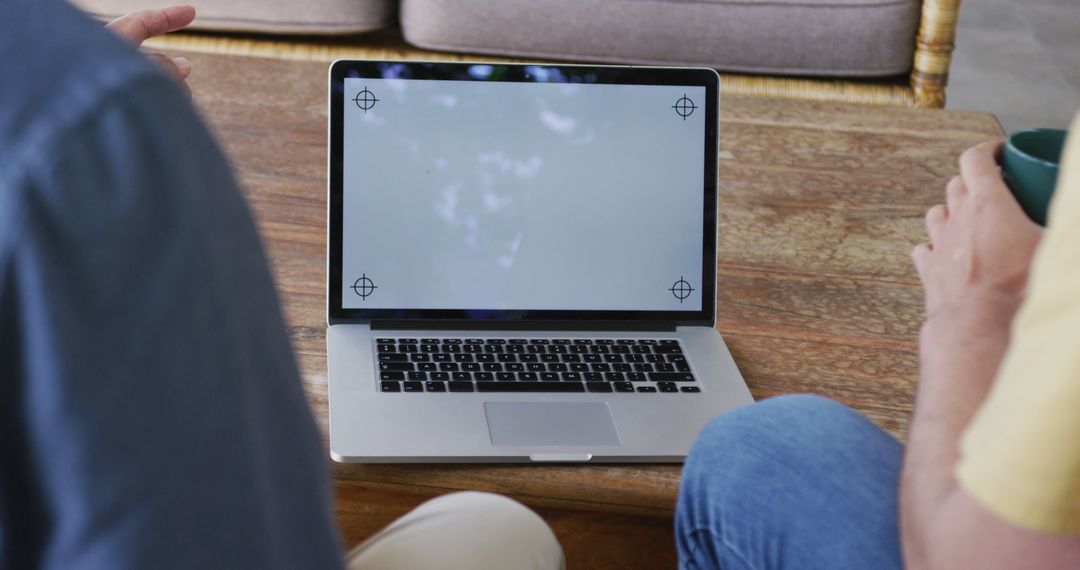 Two People Discussing Work on Open Laptop with Blank Screen - Free Images, Stock Photos and Pictures on Pikwizard.com