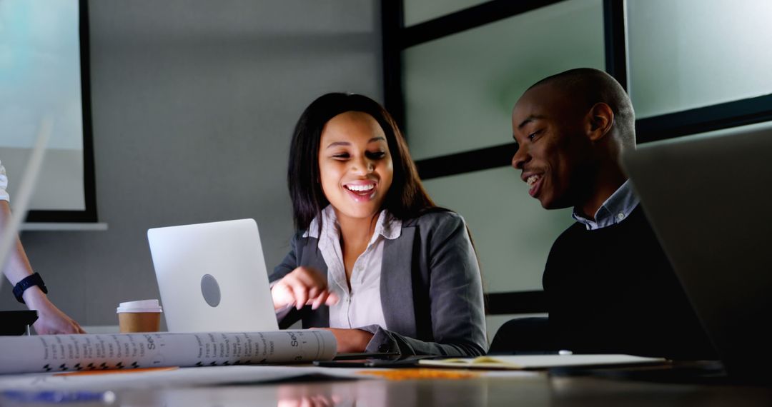 Business Colleagues Fist Bump in Vibrant Office Discussion