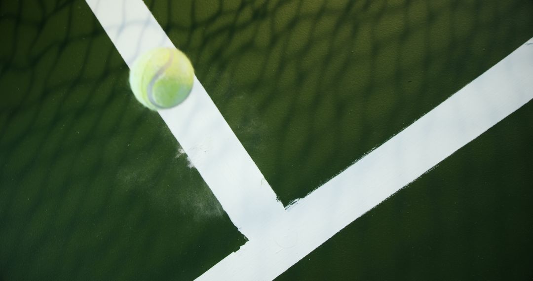 Tennis Ball Crossing White Line on Green Court - Free Images, Stock Photos and Pictures on Pikwizard.com