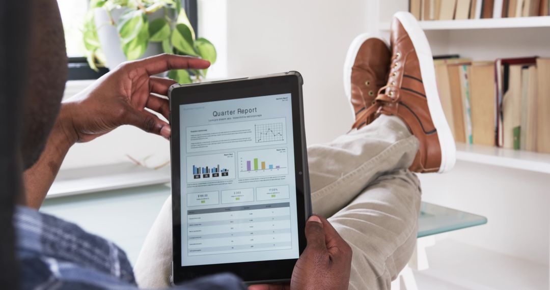 Professional Analyzing Quarter Report on Tablet in Modern Office