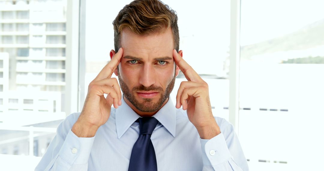 Focused Businessman Concentrating in Modern Office Space - Free Images, Stock Photos and Pictures on Pikwizard.com