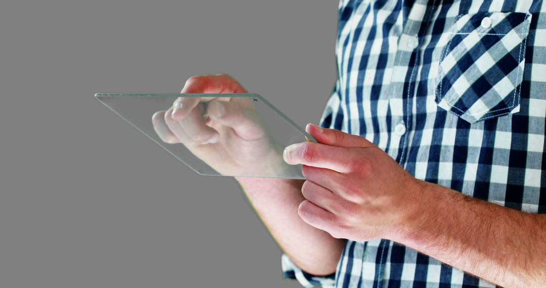 Man Using Transparent Tablet on Grey Background - Free Images, Stock Photos and Pictures on Pikwizard.com