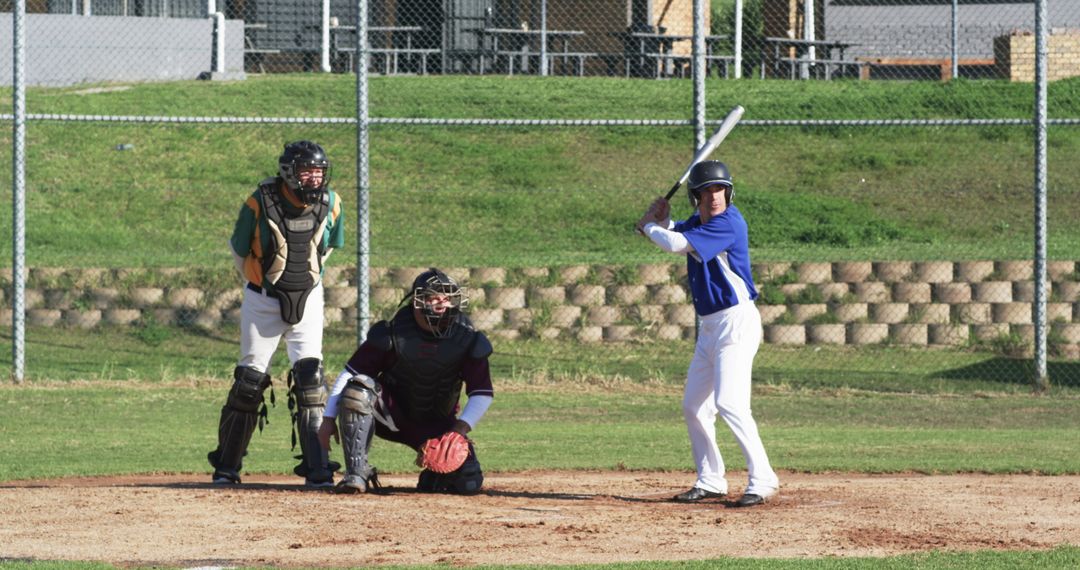 Baseball Game in Action with Batter and Catcher on Sunny Day
