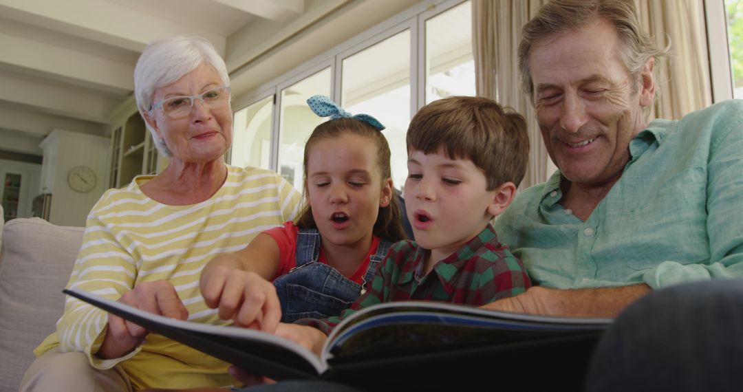 Grandparents Enjoying Storytime with Enthusiastic Grandchildren at Home - Free Images, Stock Photos and Pictures on Pikwizard.com