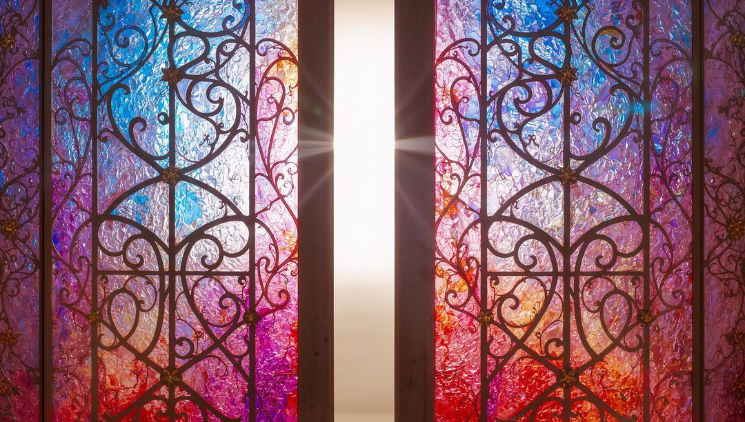 Ornate Wrought Iron Scrollwork Behind Colorful Stained Glass