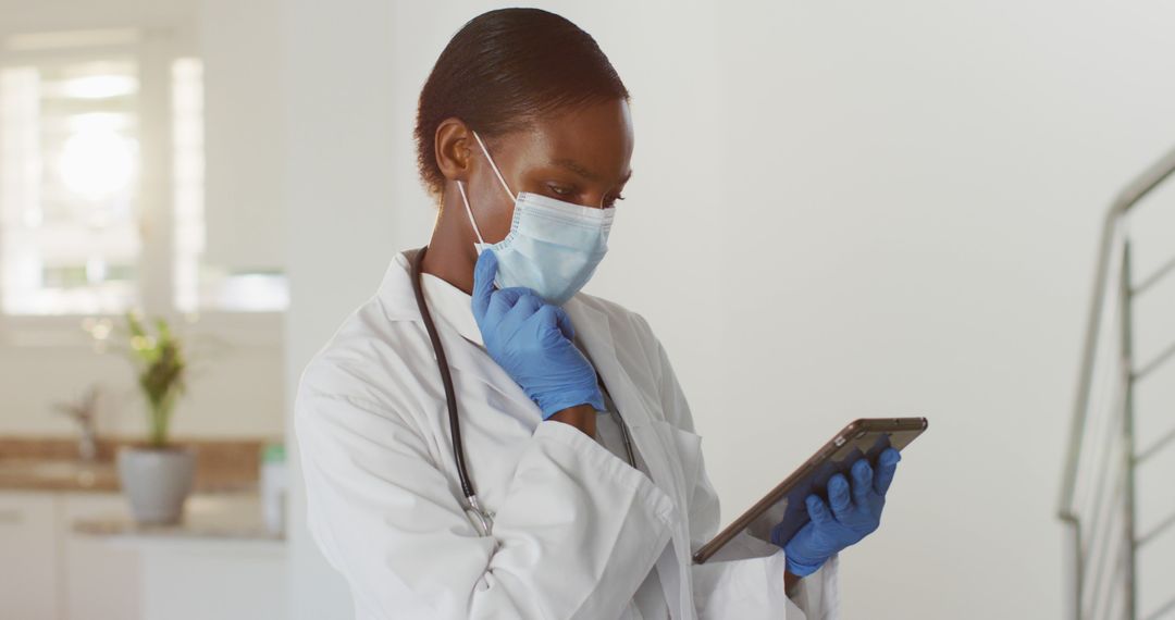 Healthcare Professional with Tablet Wearing Mask and Gloves - Free Images, Stock Photos and Pictures on Pikwizard.com