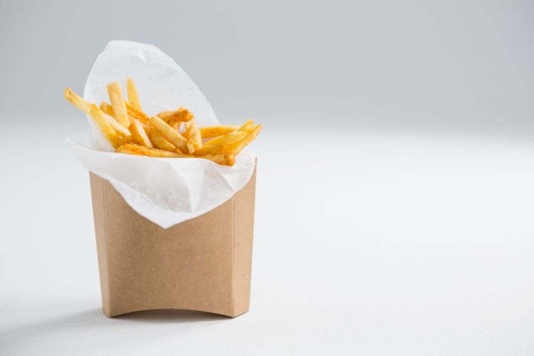 Close Up of French Fries in Paper Bag on Table - Free Images, Stock Photos and Pictures on Pikwizard.com