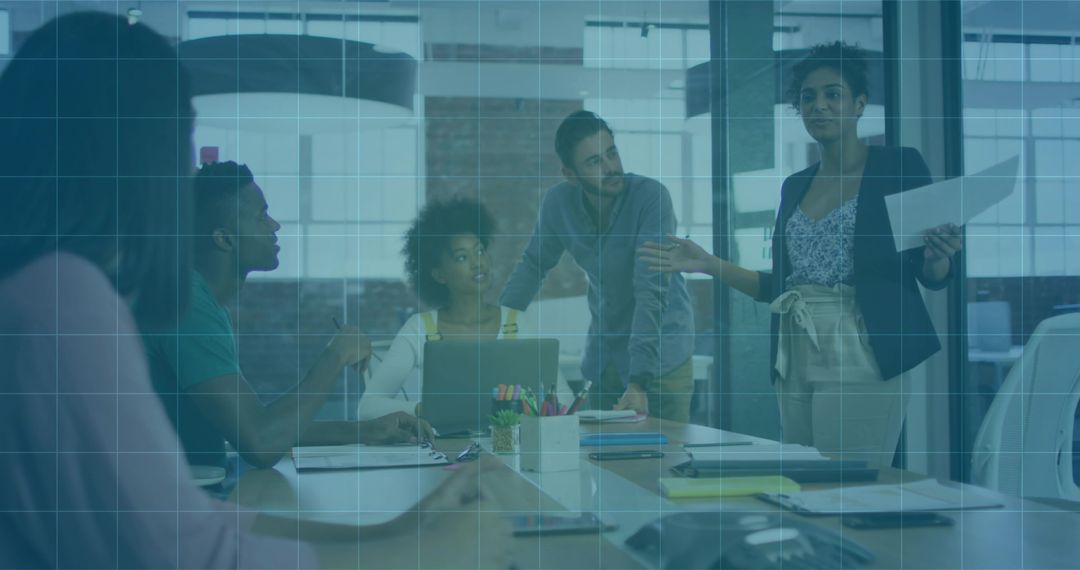 Leading presenter guiding team through strategic brainstorming in glass conference room
